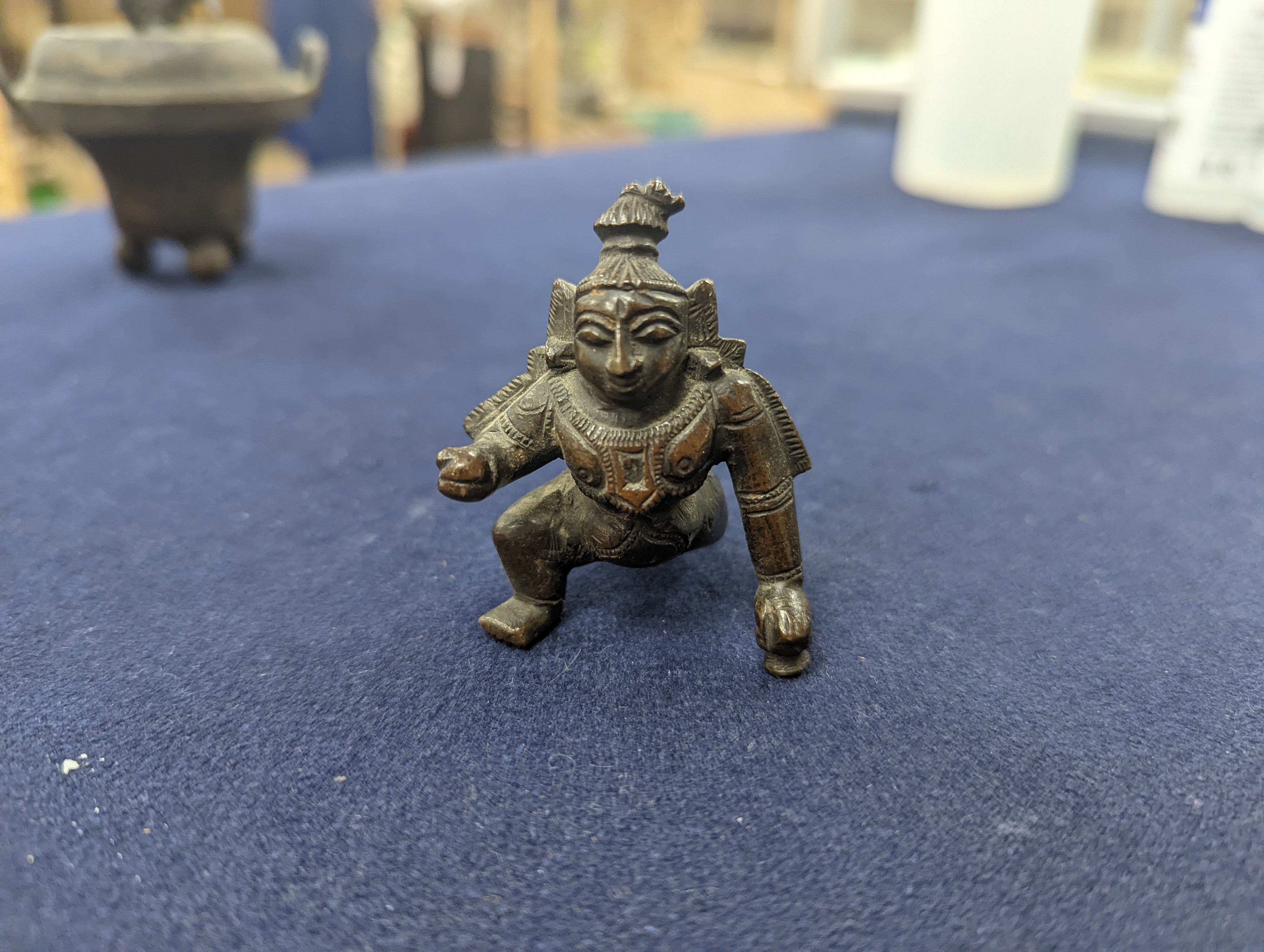 A Chinese gilt copper figure, a Chinese Dog of Fo, a bell, a censer, six Indian bronze figures and a scroll box